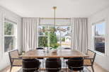 Experience elegant dining in this beautifully appointed space, featuring a rustic wooden table perfect for gatherings.