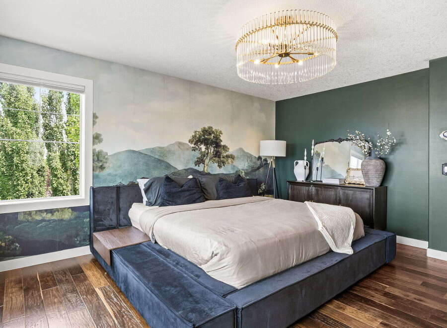 Experience luxury in this master bedroom featuring a stunning mural wallpaper that creates a serene, natural ambiance.