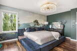 Experience luxury in this master bedroom featuring a stunning mural wallpaper that creates a serene, natural ambiance.