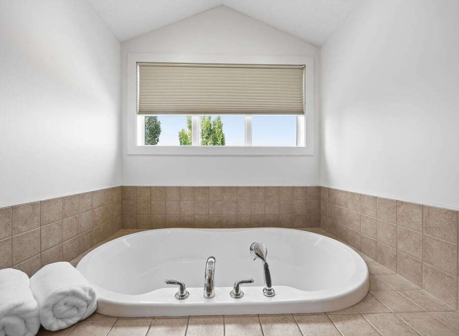Indulge in relaxation in this luxurious bathroom featuring a spacious soaking tub, perfect for unwinding after a long day.