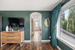 Step into a beautifully designed living space featuring a modern flat-screen TV mounted above a stylish wooden dresser.