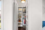 Discover organized living with this charming walk-in closet, featuring ample shelving and hanging space for all your essentials.