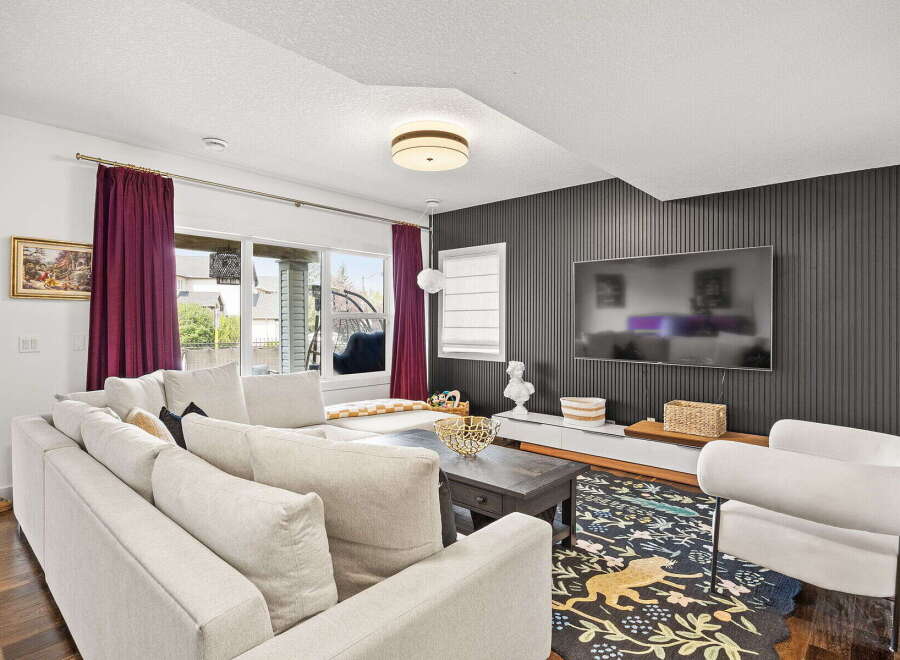 Step into this inviting living room, featuring a spacious sectional sofa perfect for gatherings and a stylish dark wood coffee table.