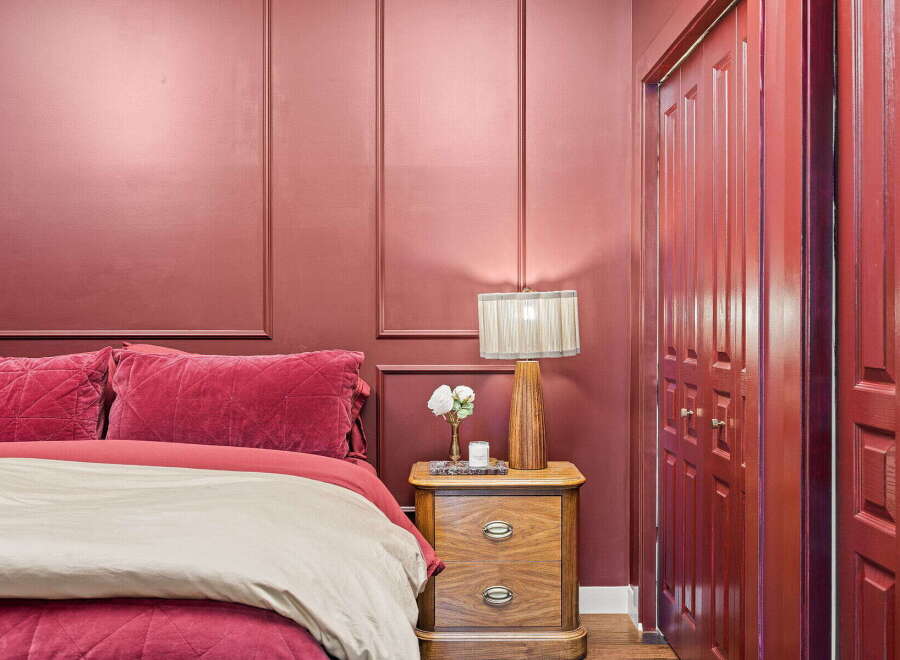 Experience luxurious comfort in this stunning bedroom featuring a plush velvet bed adorned with diamond-tufted pillows and a soft duvet.