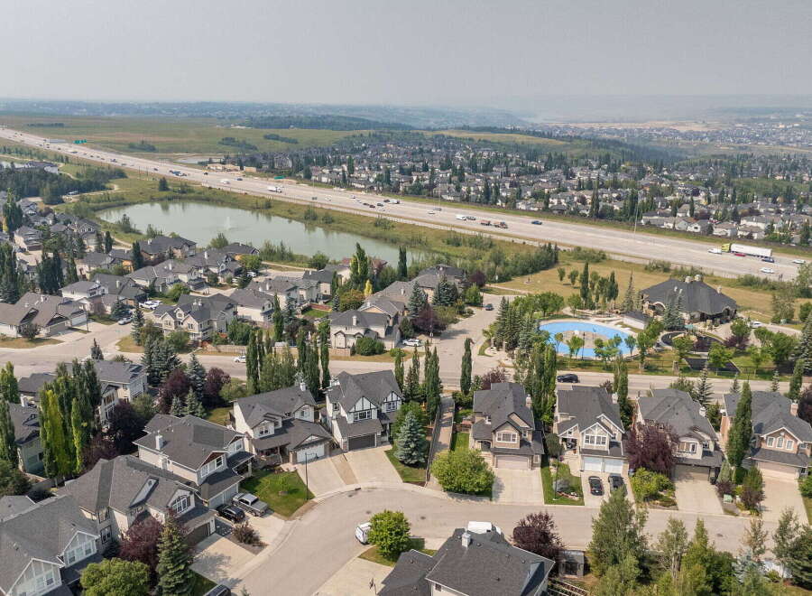 Discover this stunning aerial view of a suburban neighborhood, showcasing a collection of well-maintained homes with elegant architecture and manicured lawns.