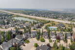 Discover this stunning aerial view of a suburban neighborhood, showcasing a collection of well-maintained homes with elegant architecture and manicured lawns.