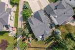 Discover this stunning aerial view showcasing a beautifully landscaped backyard with a private hot tub and a children's playset.