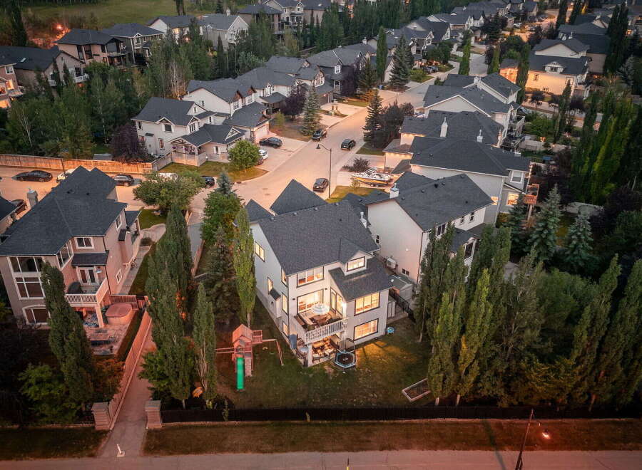 Experience luxury living in this stunning multi-story home, featuring a spacious backyard with a playground and trampoline, perfect for family fun.