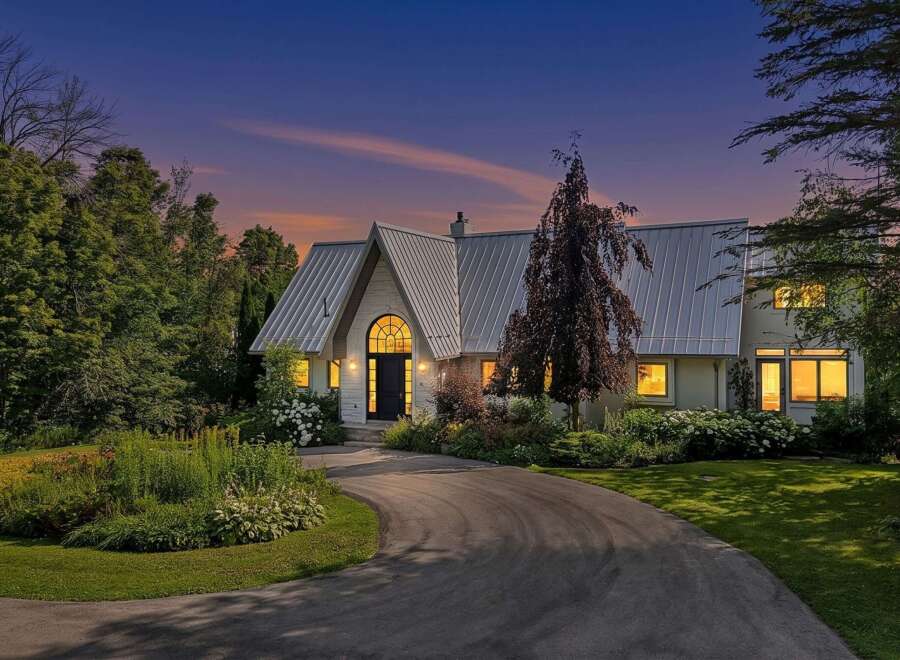 Experience the charm of this stunning home, featuring a unique metal roof and an arched entryway that exudes architectural elegance.