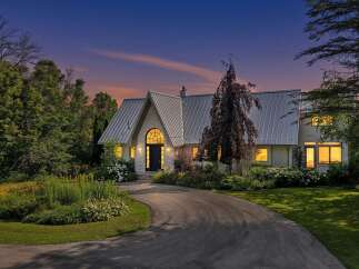 Experience the charm of this stunning home, featuring a unique metal roof and an arched entryway that exudes architectural elegance.