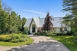 Discover this stunning home featuring a unique architectural design with a striking metal roof and an arched entryway.