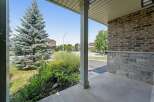 Welcome to this charming property featuring a welcoming porch with a sturdy pillar and a beautiful brick and stone exterior.
