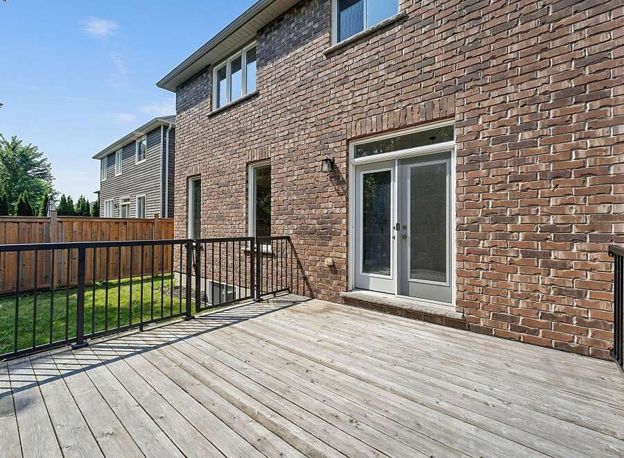 Step outside onto a spacious wooden deck, perfect for entertaining or enjoying a quiet evening.