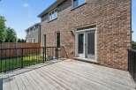 Step outside onto a spacious wooden deck, perfect for entertaining or enjoying a quiet evening.