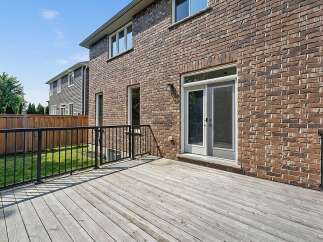 Step outside onto a spacious wooden deck, perfect for entertaining or enjoying a quiet evening.