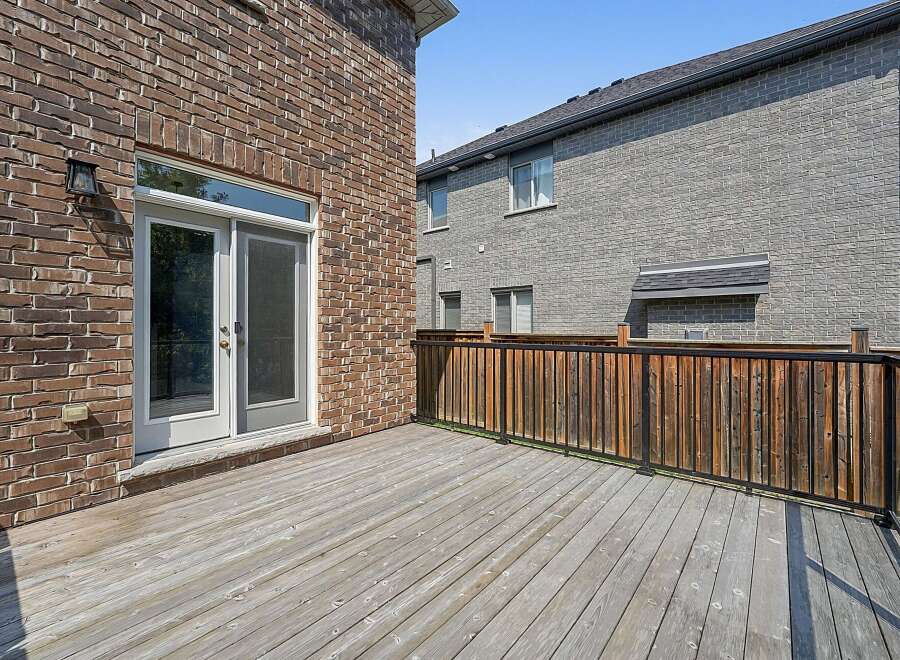 Step outside onto this expansive wooden deck, perfect for entertaining or relaxing.