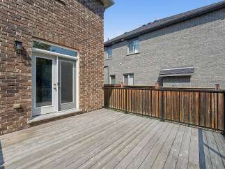 Step outside onto this expansive wooden deck, perfect for entertaining or relaxing.