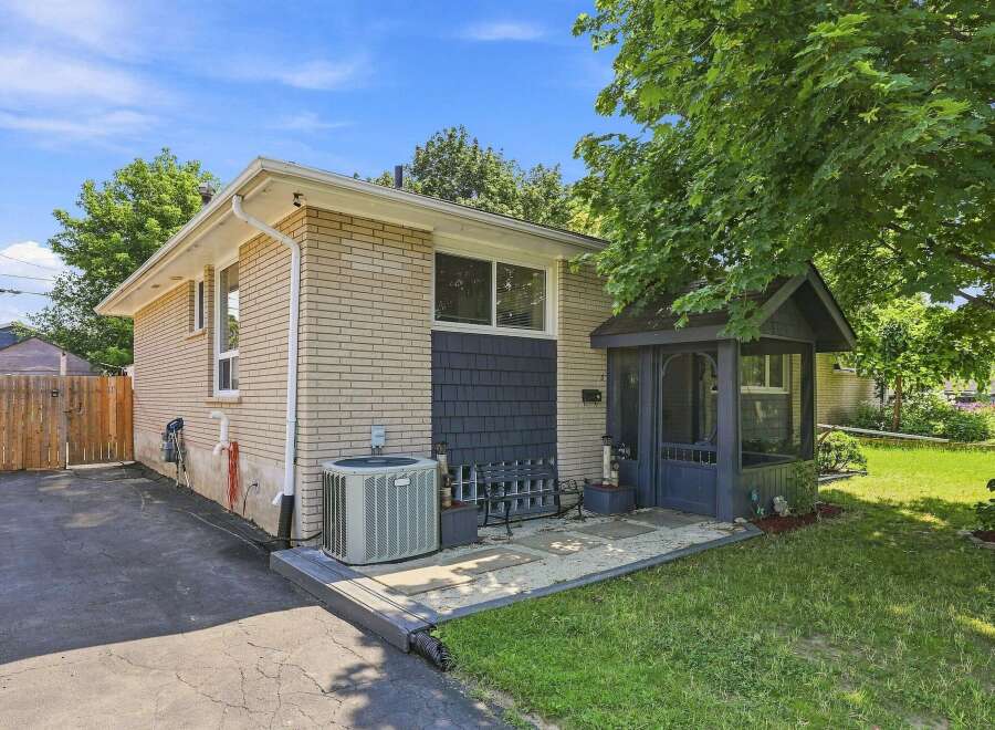 Discover this charming property featuring a light brick exterior and a welcoming screened-in porch, perfect for enjoying the outdoors in comfort.