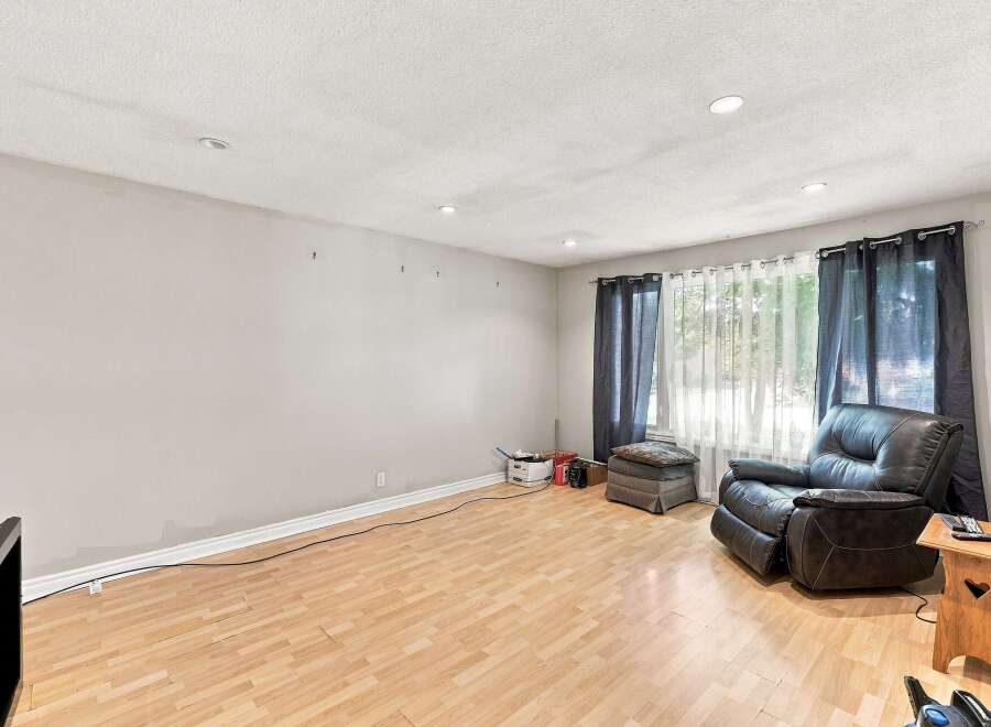 Discover comfort and style in this inviting living space, featuring a plush leather recliner perfect for relaxation.