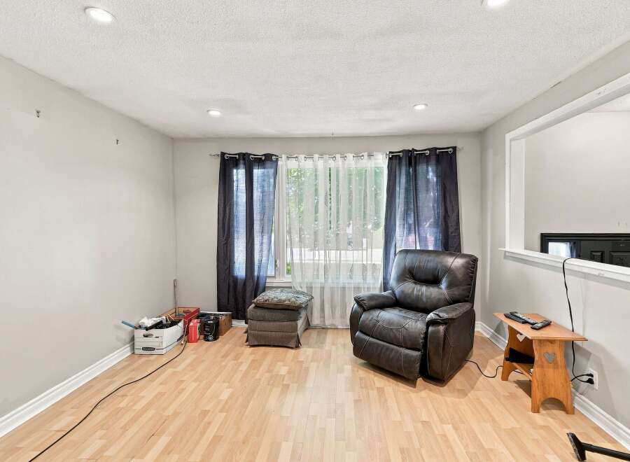 Discover comfort and style in this inviting living space, featuring a plush leather recliner perfect for relaxation.