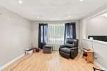 Discover comfort and style in this inviting living space, featuring a plush leather recliner perfect for relaxation.