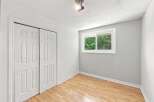 Discover comfort and style in this inviting bedroom, featuring a spacious closet with double doors and a large window that floods the room with natural light.
