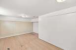 This spacious room features a neutral color palette with elegant wainscoting on the walls, offering a classic and versatile backdrop.