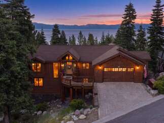 Experience luxury living in this stunning mountain home with breathtaking lake views.