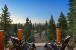 Enjoy breathtaking views from this stunning property, featuring a spacious balcony with comfortable lounge chairs perfect for relaxation.