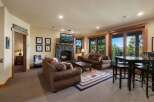 Experience ultimate relaxation in this cozy living room, featuring a grand stone fireplace and comfortable seating.