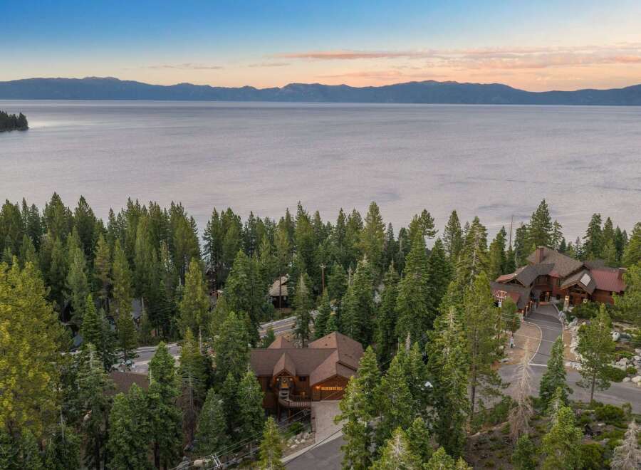 Nestled amidst towering pine trees with a breathtaking lake view, this stunning mountain home offers unparalleled luxury and serenity.
