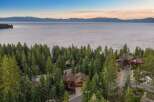 Nestled amidst towering pine trees with a breathtaking lake view, this stunning mountain home offers unparalleled luxury and serenity.