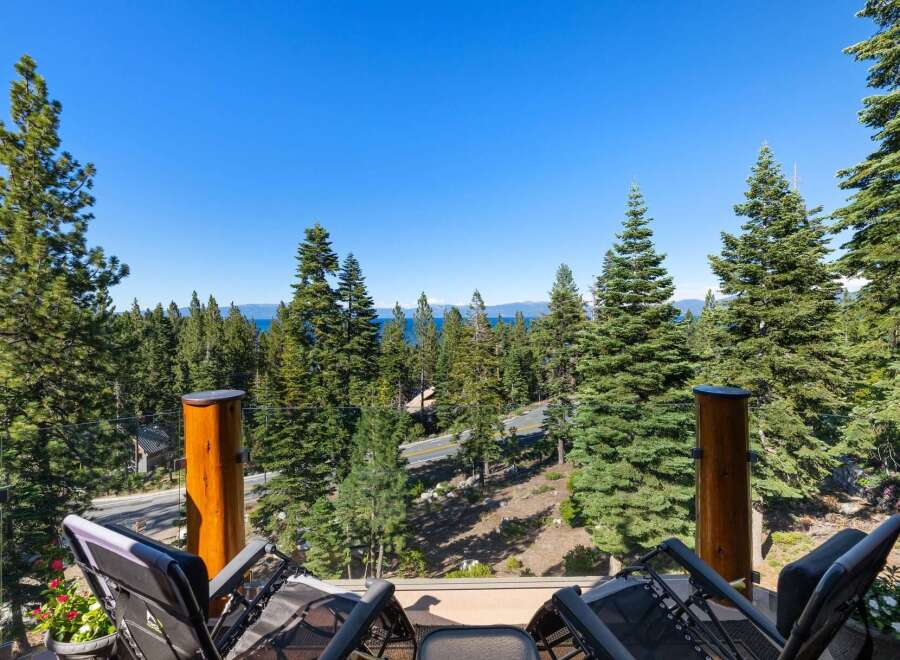 Enjoy breathtaking lake and mountain views from this stunning property, nestled amidst towering pine trees.
