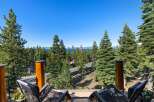 Enjoy breathtaking lake and mountain views from this stunning property, nestled amidst towering pine trees.