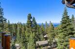 Experience breathtaking lake and mountain views from this stunning property, nestled amidst a lush forest of towering pine trees.