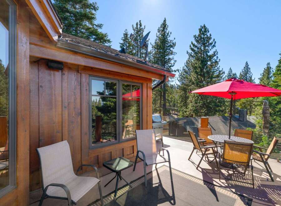 Enjoy outdoor living on this spacious deck, perfect for entertaining or relaxing amidst the trees.