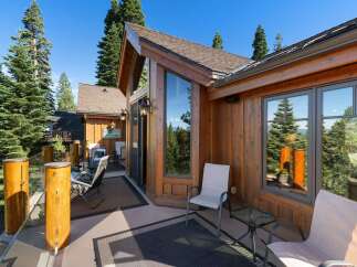 Enjoy breathtaking mountain and lake views from this stunning wooden deck, perfect for outdoor entertaining or quiet relaxation.