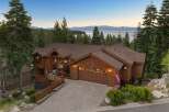 Experience luxurious mountain living in this stunning wooden home, nestled amidst towering pine trees with breathtaking lake and mountain views.