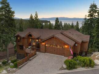 Experience luxurious mountain living in this stunning wooden home, nestled amidst towering pine trees with breathtaking lake and mountain views.