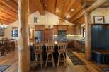 Experience rustic charm in this spacious kitchen featuring a large island with bar seating, perfect for casual dining and entertaining.