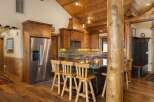 Experience rustic charm in this spacious kitchen featuring warm wood cabinetry and a large granite island perfect for entertaining.