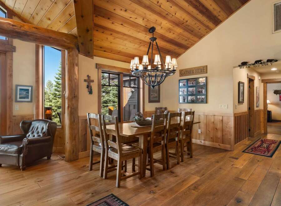 Experience rustic charm in this spacious dining room, featuring a large wooden table perfect for family gatherings.