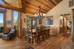 Experience rustic charm in this spacious dining room, featuring a large wooden table perfect for family gatherings.