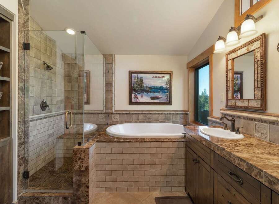 Experience luxury in this stunning bathroom featuring a spacious walk-in shower with elegant tilework and a deep soaking tub perfect for relaxation.