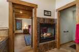 Cozy up by the gas fireplace, featuring a rich marble surround and a rustic wood mantel.