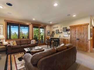 Experience breathtaking mountain views from this stunning living area, featuring a cozy seating arrangement perfect for relaxation.
