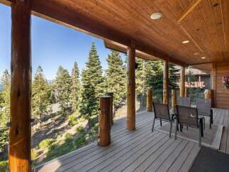 Experience breathtaking views from this stunning covered deck, perfect for enjoying the serene mountain landscape.