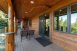 Enjoy the stunning mountain views from this expansive covered deck, perfect for outdoor dining and relaxation.