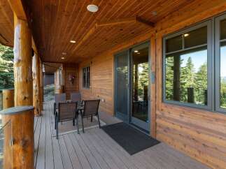 Enjoy the stunning mountain views from this expansive covered deck, perfect for outdoor dining and relaxation.