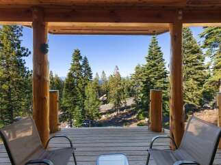 Experience breathtaking lake and mountain views from this stunning property's expansive deck, perfect for enjoying your morning coffee or evening sunsets.